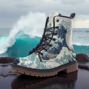 A white and blue patterned boot is placed on a rock, with a large wave crashing in the background.