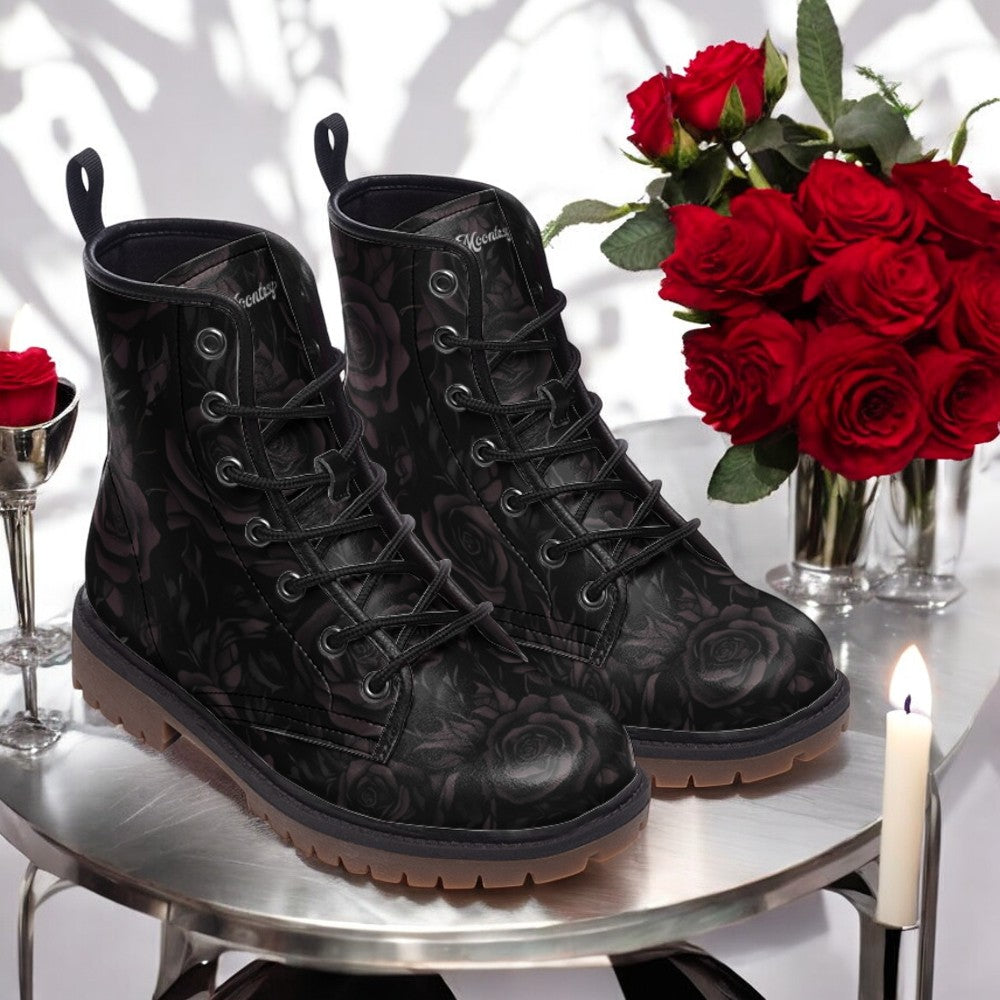 a pair of black boots sitting on top of a table