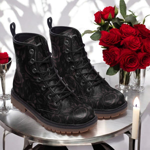 a pair of black boots sitting on top of a table