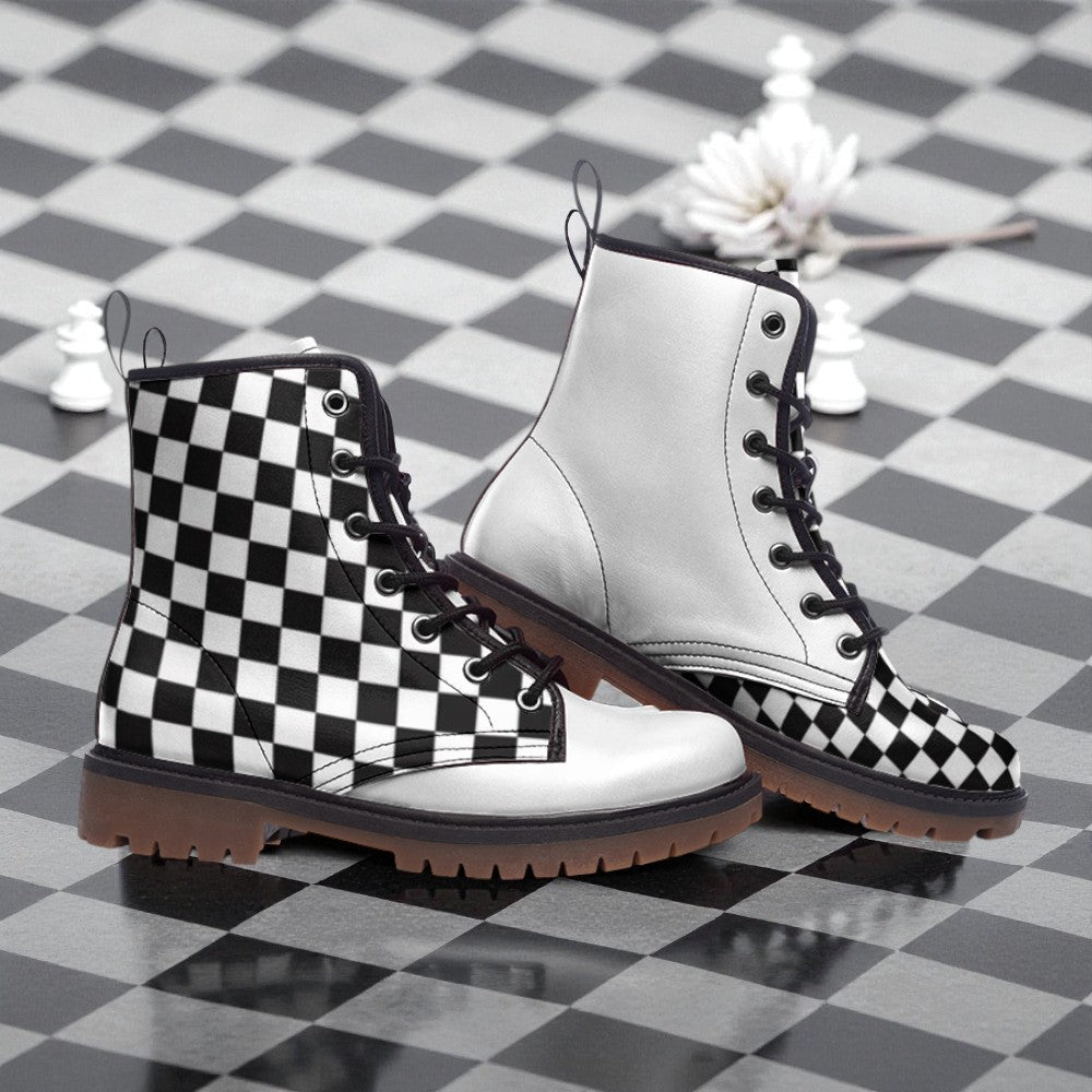 A pair of black and white checkered boots with a white sole, placed on a black and white checkered floor.