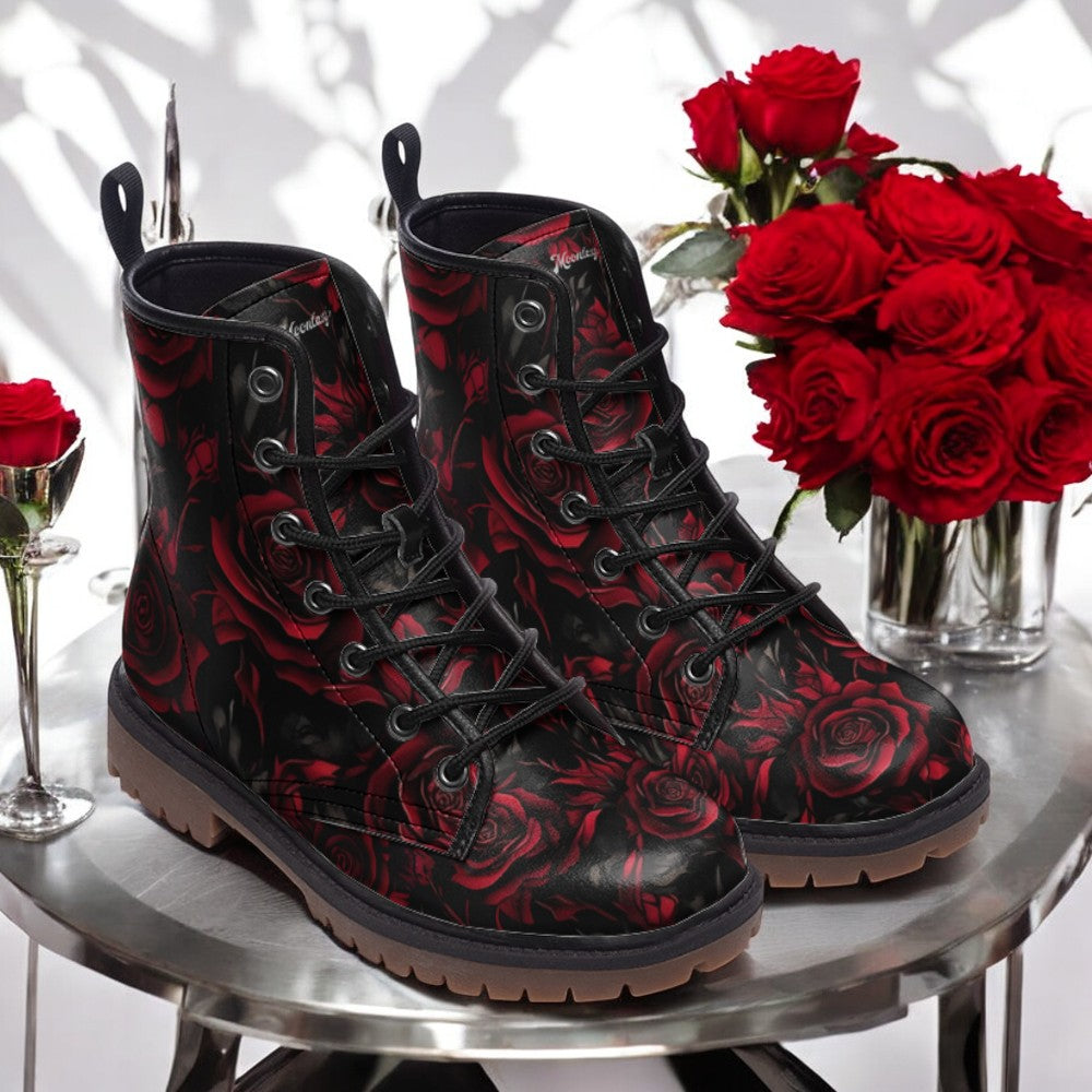 a pair of black and red boots sitting on top of a table