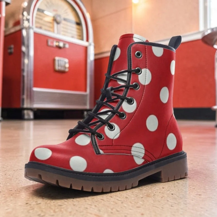 A red and white polka dot boot is placed on a tiled floor in front of a red vintage jukebox.