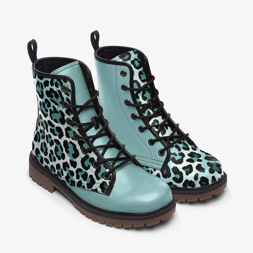 A pair of blue and black leopard print boots with black laces and a brown sole.