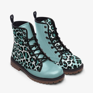 A pair of blue and black leopard print boots with black laces and a brown sole.