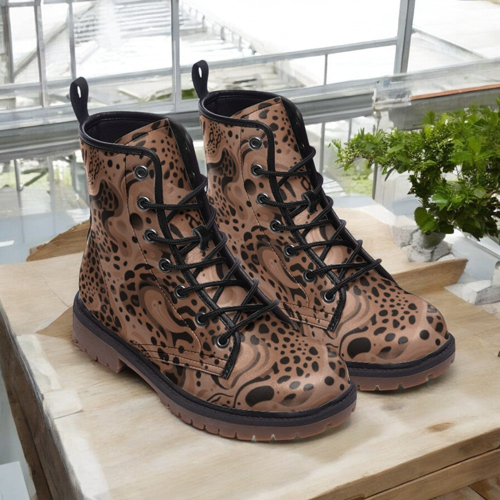 a pair of leopard print boots sitting on top of a wooden table