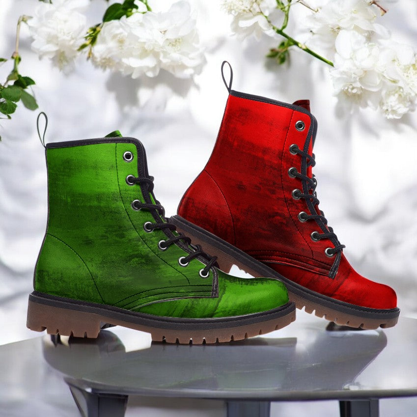 A pair of green and red combat boots are displayed against a white background with white flowers.
