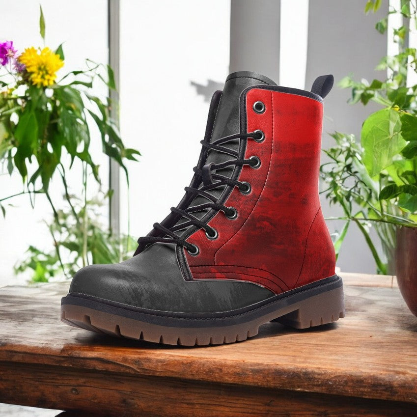 A red and black boot is displayed on a wooden surface, with a potted plant visible in the background.