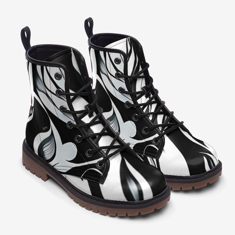 a pair of black and white boots on a white background