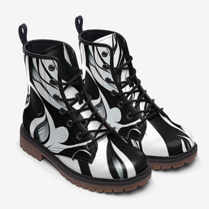 a pair of black and white boots on a white background