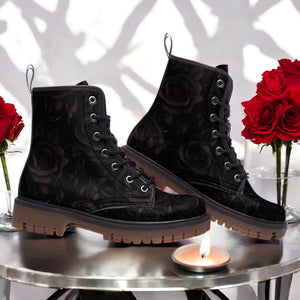 a pair of black boots sitting on top of a table