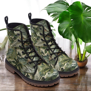 a pair of green boots sitting on top of a wooden table