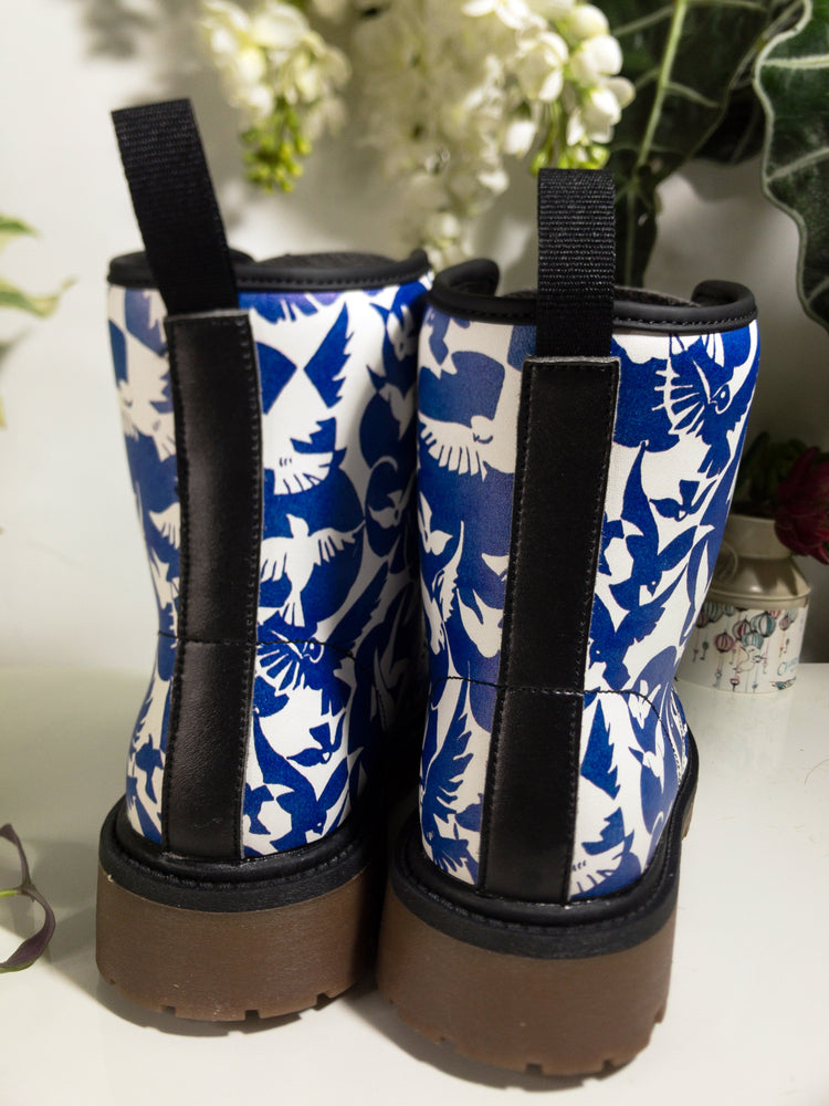 a pair of blue and white boots sitting on top of a table