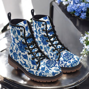 a pair of blue and white boots sitting on top of a table