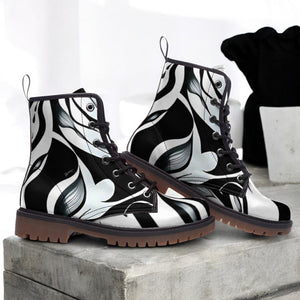 a pair of black and white boots sitting on top of a cement block