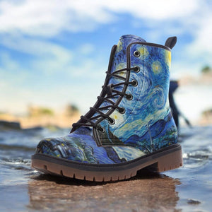 a close up of a pair of boots with a painting on them
