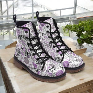 a pair of white and purple boots sitting on top of a wooden table