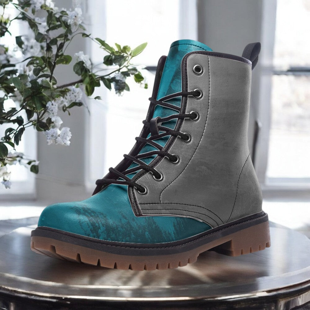 A teal and gray boot is displayed on a round table, with a plant in the background.