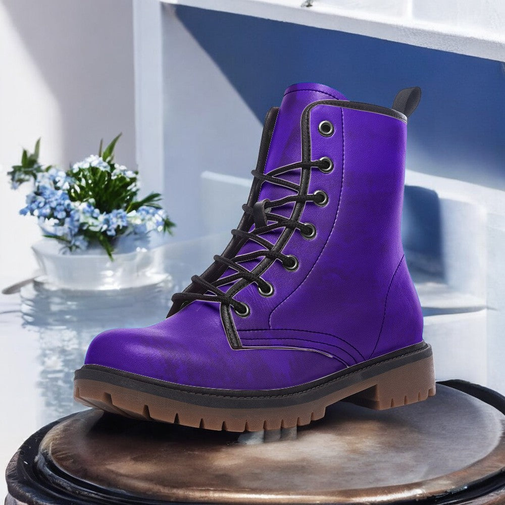 a pair of purple boots sitting on top of a table