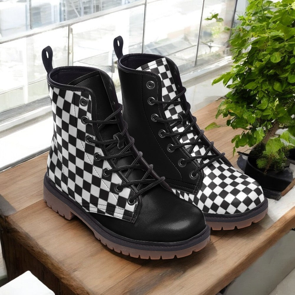 A pair of black and white checkered boots are displayed on a wooden surface, with a potted plant visible in the background.