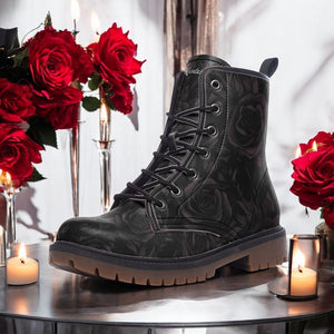 a pair of black boots sitting on top of a table