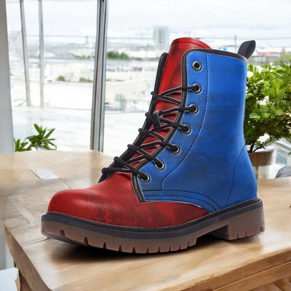 A red and blue boot is displayed on a wooden surface, with a window and greenery visible in the background.