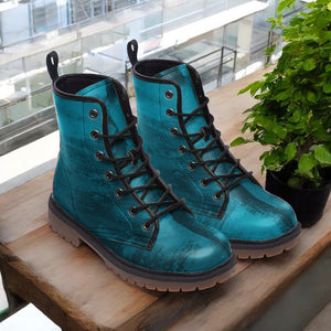 a pair of blue boots sitting on top of a wooden table