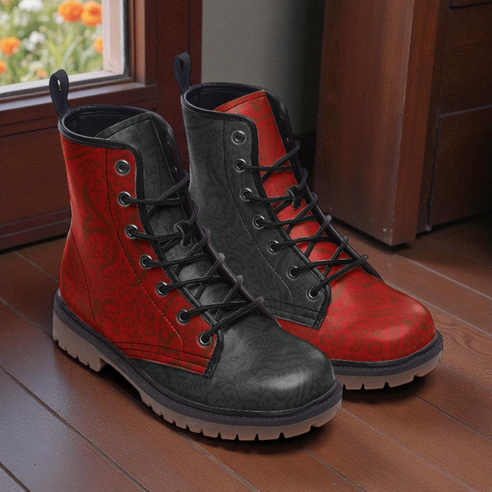 A pair of red and black patterned boots are placed on a wooden floor, with a window and wooden door visible in the background.