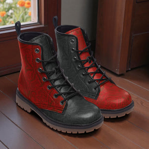 A pair of red and black patterned boots are placed on a wooden floor, with a window and wooden door visible in the background.