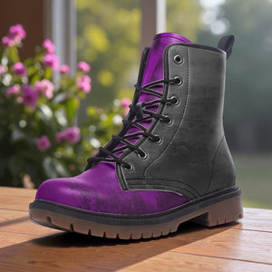 A purple and gray combat boot is displayed on a wooden surface, with a blurred background of pink flowers.