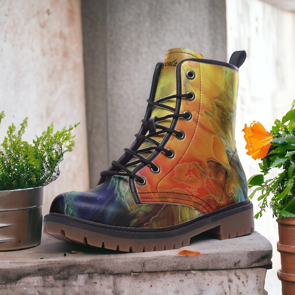 a pair of colorful boots sitting next to a potted plant