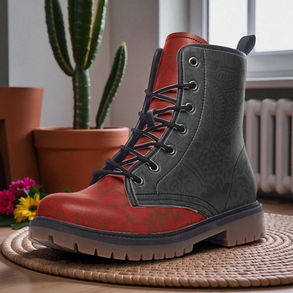 A red and gray patterned boot is displayed on a woven mat, with a potted cactus plant and a window in the background.