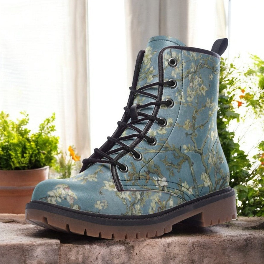 a pair of blue boots sitting on top of a stone wall