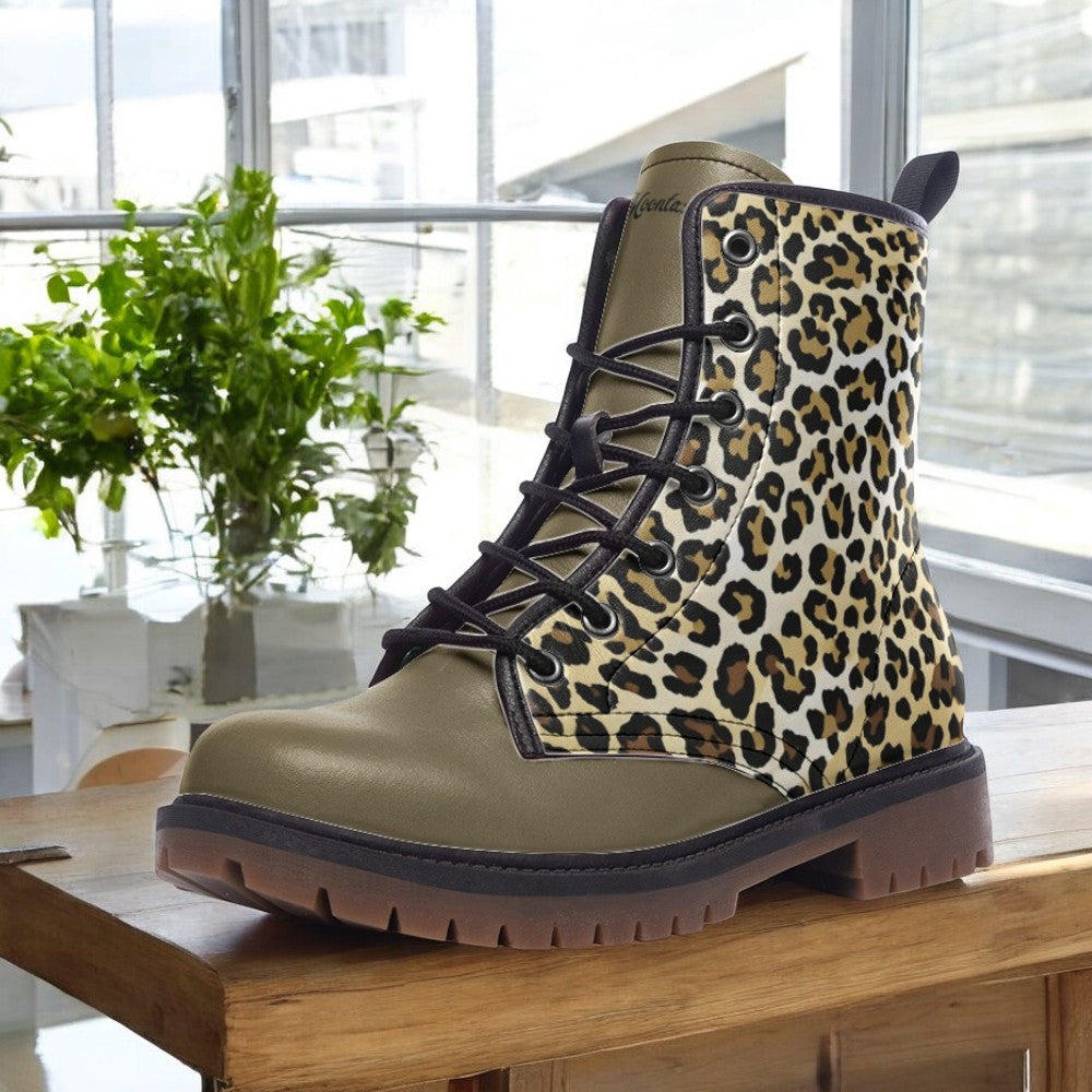A leopard print boot is displayed on a wooden surface, with a window and potted plants in the background.