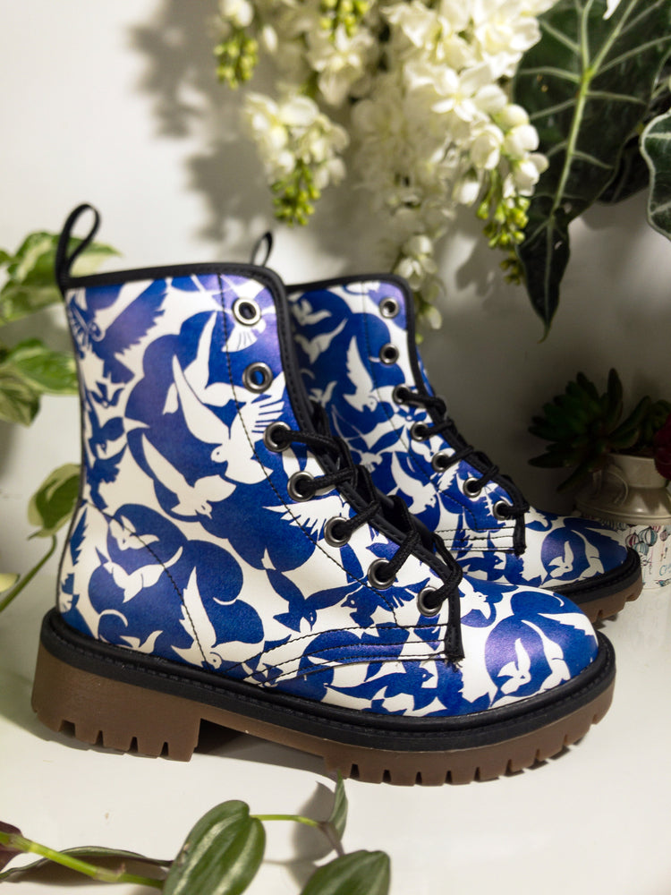 a pair of blue and white boots sitting on top of a table