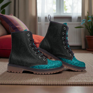 A pair of black and teal patterned boots are placed on a rug in a room with a window and a potted plant.