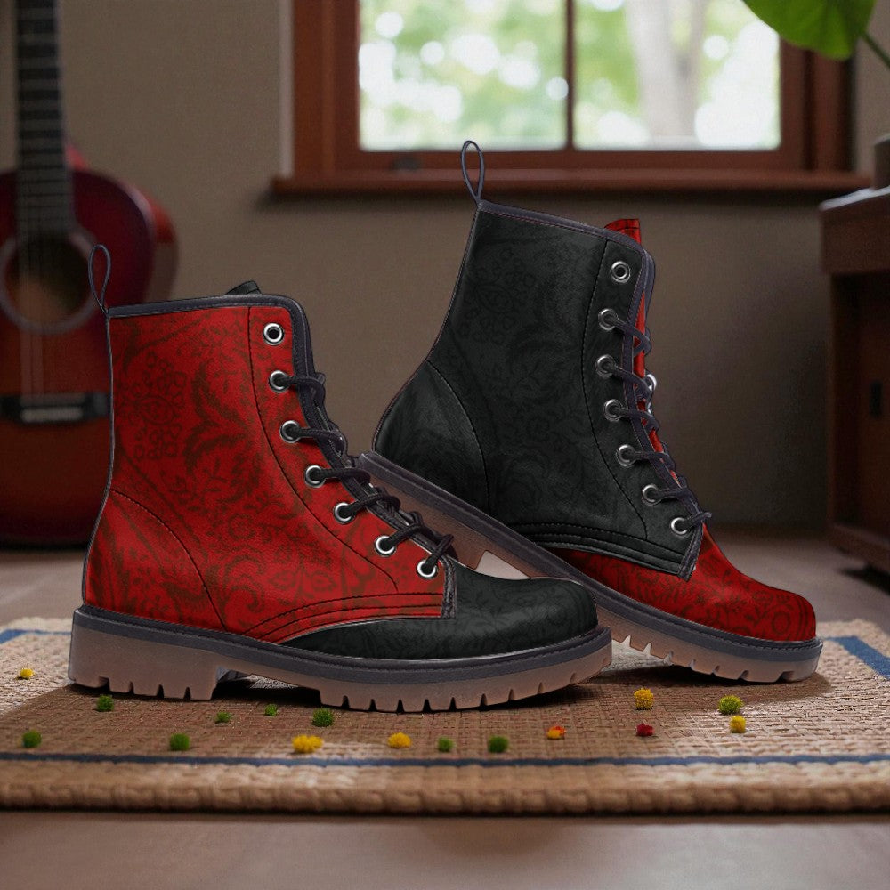 A pair of red and black patterned boots with laces and soles, placed on a woven mat with scattered small objects around them.