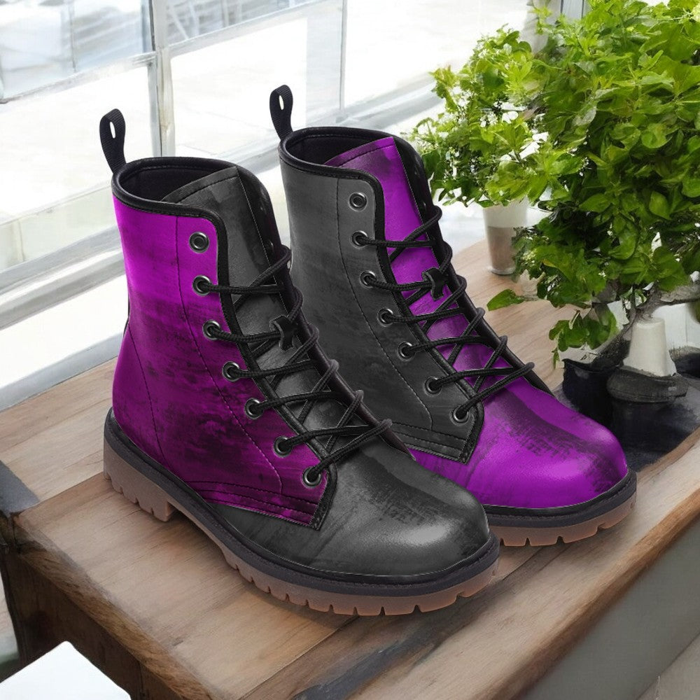 A pair of purple and black combat boots are displayed on a wooden surface, with a potted plant visible in the background.