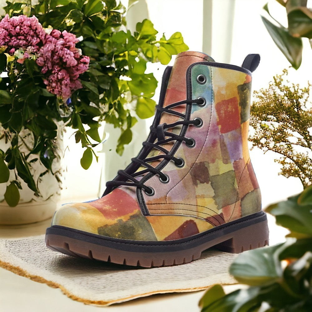 a pair of colorful boots sitting next to a potted plant