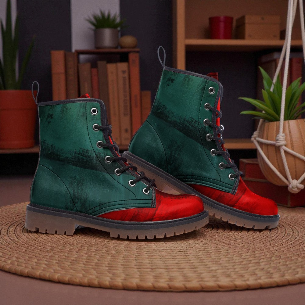 A pair of green and red combat boots with laces and soles, placed on a woven mat in a room with bookshelves and potted plants.