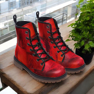 a pair of red boots sitting on top of a wooden table