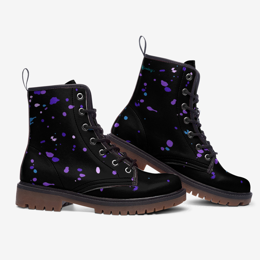 A pair of black boots with purple splatter designs on them.