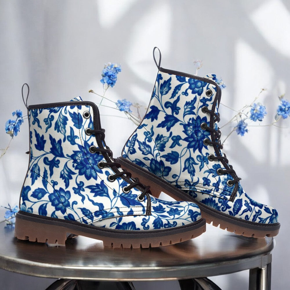 a pair of blue and white boots sitting on top of a table