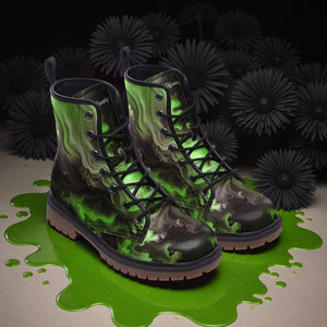 A pair of green and black camouflage boots with a unique, abstract pattern are shown on a surface with green liquid, surrounded by black flowers.
