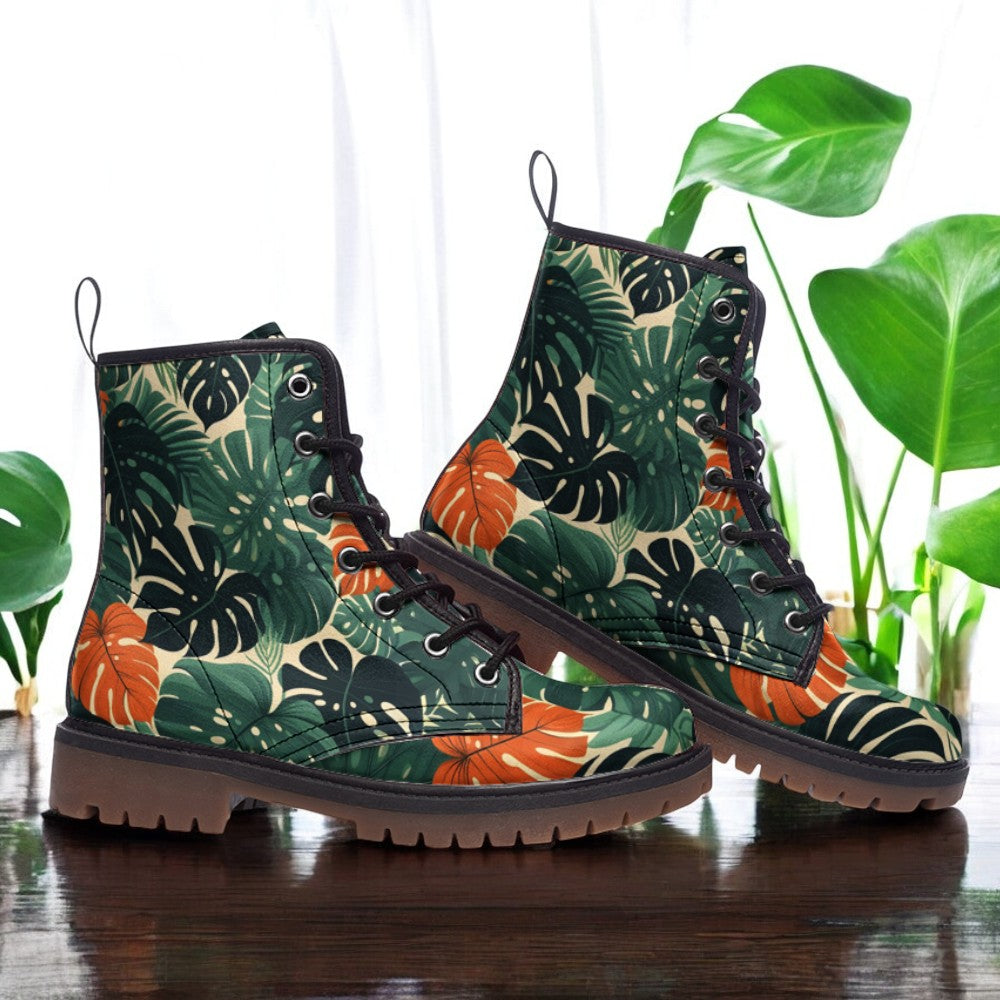 a pair of green and orange boots sitting on top of a wooden table