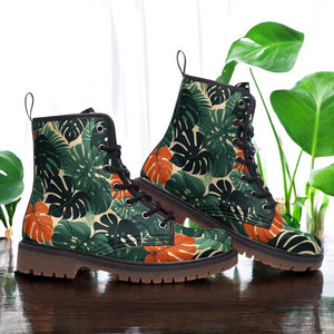 a pair of green and orange boots sitting on top of a wooden table