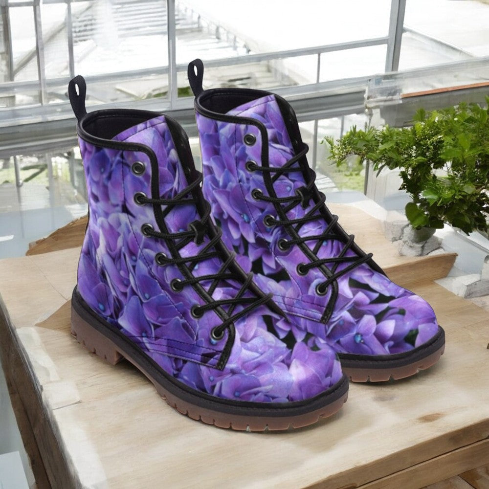 a pair of purple boots sitting on top of a wooden table