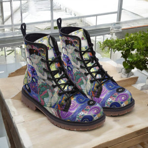 a pair of colorful boots sitting on top of a wooden table