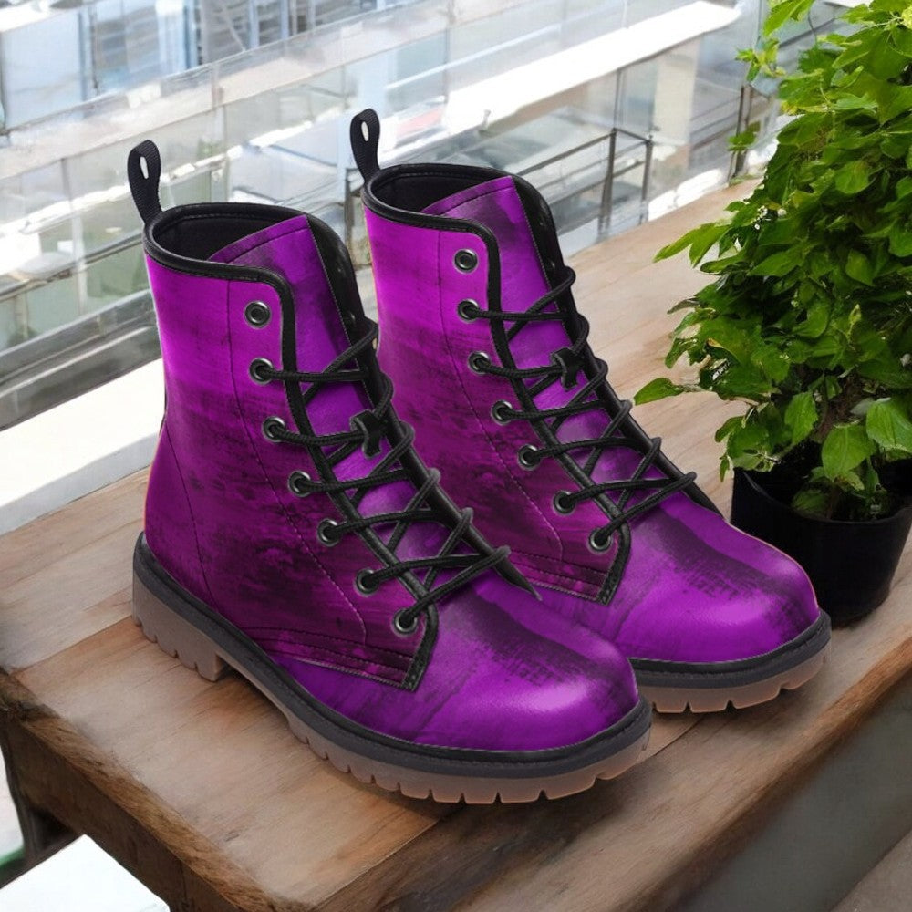 a pair of purple boots sitting on top of a wooden table