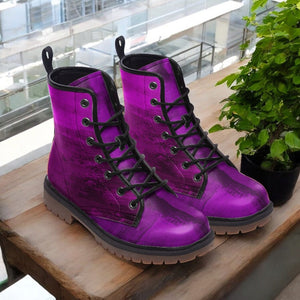 a pair of purple boots sitting on top of a wooden table